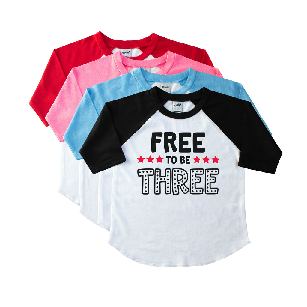Toddler black sleeve raglan with Free to be Three in Black with red stars on the front