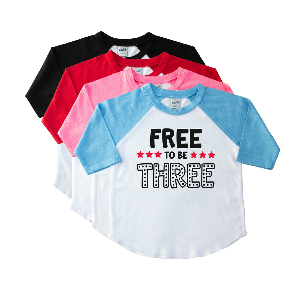Blue sleeve toddler raglan with Free to be Three on the front in black with red stars