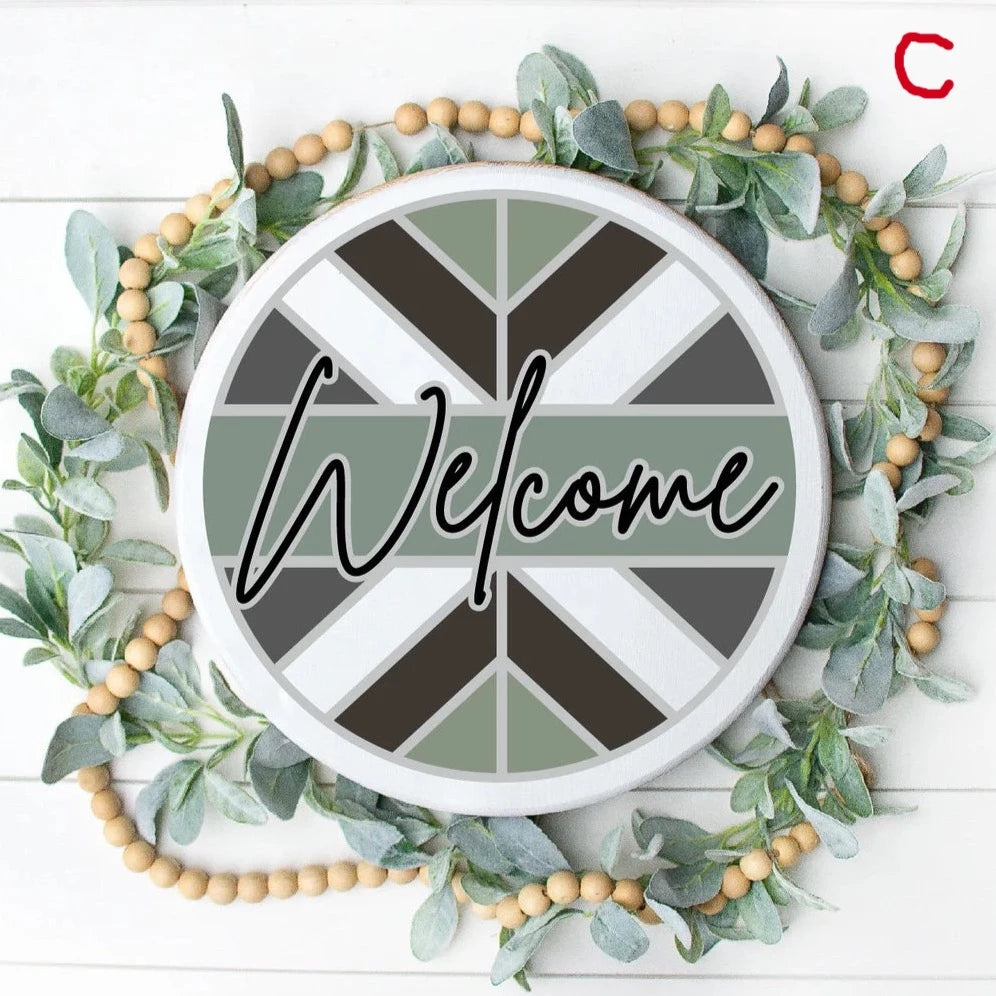 Round wooden door hanger with angled chevron pattern with Welcome in the center in White, Black, Sage Green, and Grey