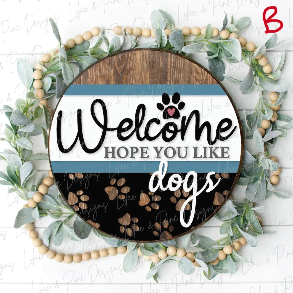 Round wooden door hanger that says Welcome Hope you Like Dogs in brown, white, blue, and black