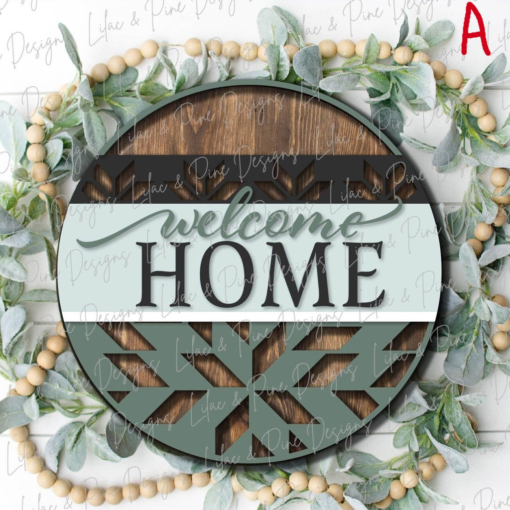 Round Wooden Door hanger that says Welcome Home with a floral quilted cutout bottom in brown black sage green and light blue
