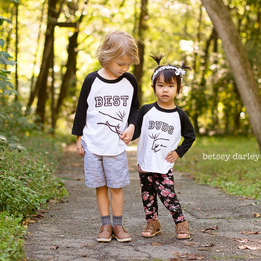 Little boy and girl wearing black sleeve raglans with Best Buds Fist bump designs on them