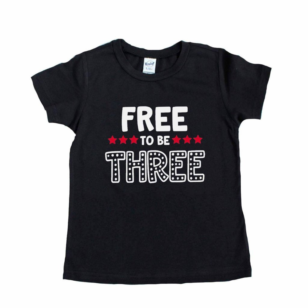 Black shirt with Free to be Three Writing and red star accents