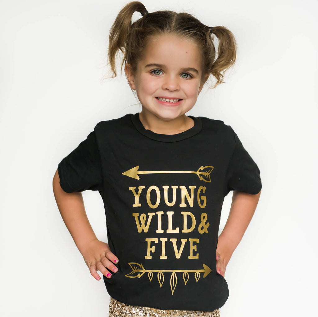 Little girl wearing black young wild and five tee with gold writing